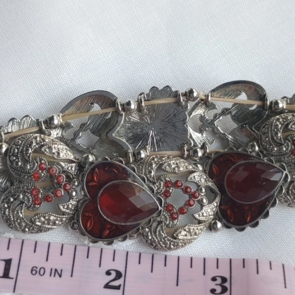 Red enamel and rhinestone encrusted silvertone heart-shaped stretchy bracelet
